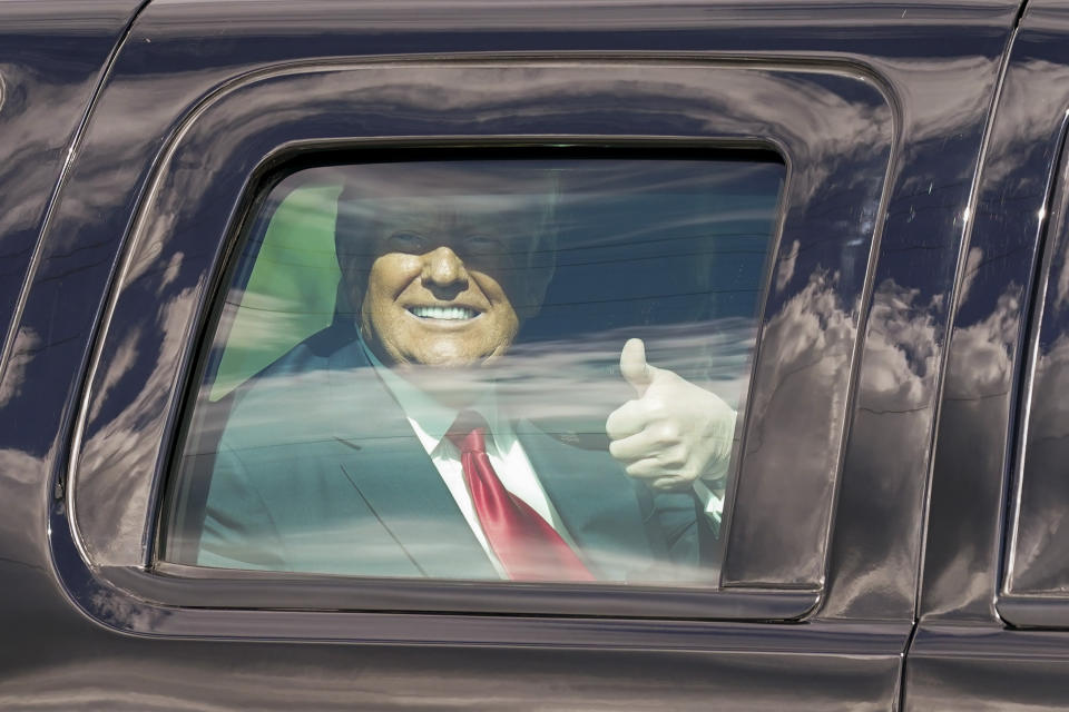 President Donald Trump gestures to supporters en route to his Mar-a-Lago Florida Resort on Wednesday, Jan. 20, 2021, in West Palm Beach, Fla. (AP Photo/Lynne Sladky)