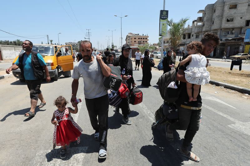 Displaced Palestinians, who fled north Gaza after they were ordered by Israeli army to move southward, amid Israel-Hamas conflict, arrive in Nuseirat in the central Gaza Strip