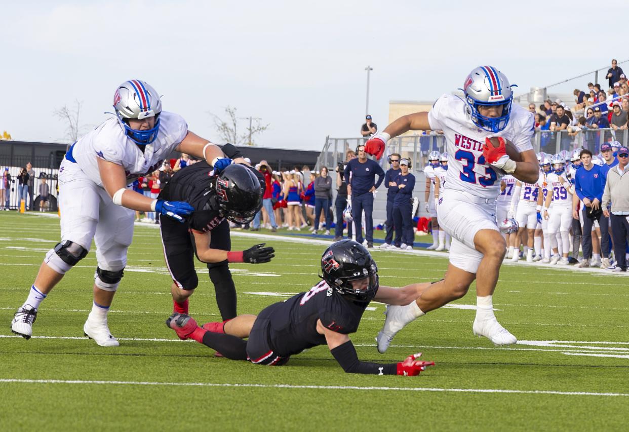Westlake running back Jack Kayser breaks away from a Lake Travis defender for a third-quarter touchdown in Saturday's 21-14 win in the Class 6A Division I state quarterfinals at The Pfield. The Chaparrals will face Galena Park North Shore in next week's state semifinals.