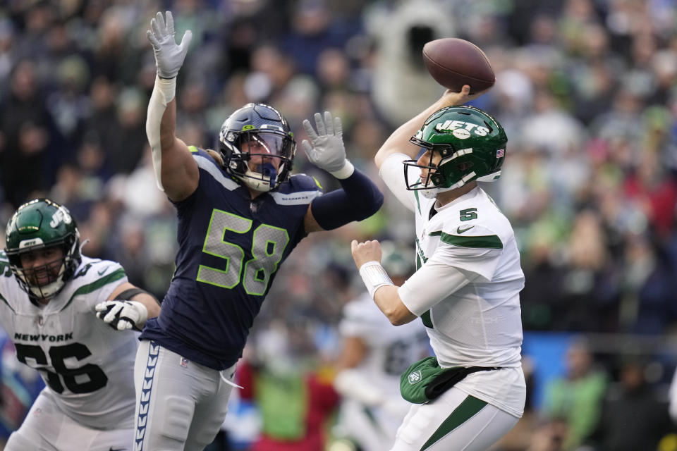 New York Jets quarterback Mike White (5) throws under pressure from Seattle Seahawks linebacker Tanner Muse (58) during the second half of an NFL football game, Sunday, Jan. 1, 2023, in Seattle. (AP Photo/Godofredo A. Vásquez)