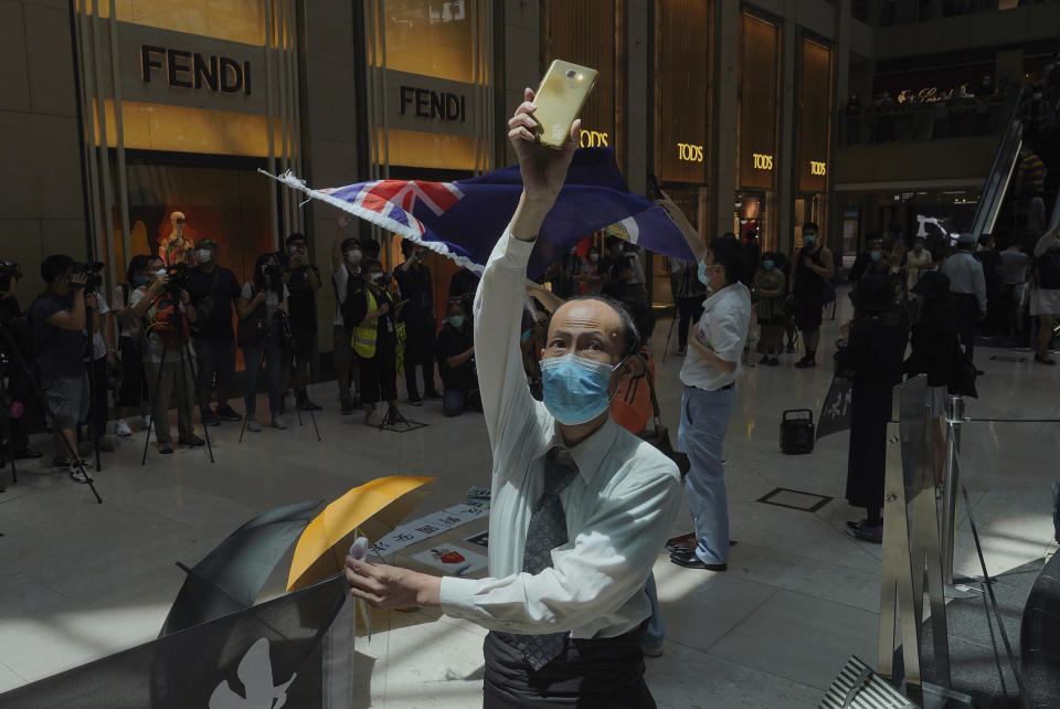 Protesters fill a shopping mall during a protest against China's national security legislation for the city, in Hong Kong, Monday, June 1, 2020. The mouthpiece of China's ruling Communist Party says U.S. moves to end some trading privileges extended to Hong Kong grossly interfere in China's internal affairs and are doomed to fail. (AP Photo/Vincent Yu)