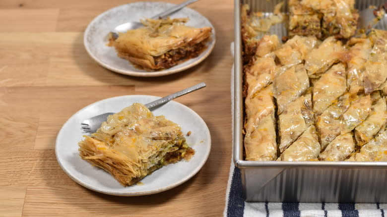 baklava served on plate next to tray