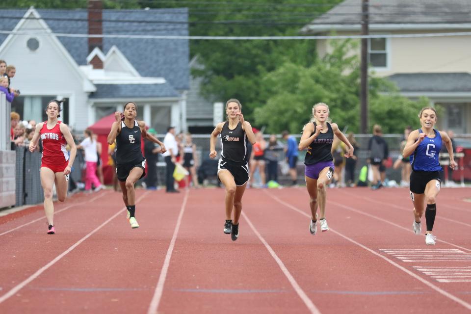 Bucyrus's Emma Tyrell and Lucas's Shelby Grover run the 200 dash.