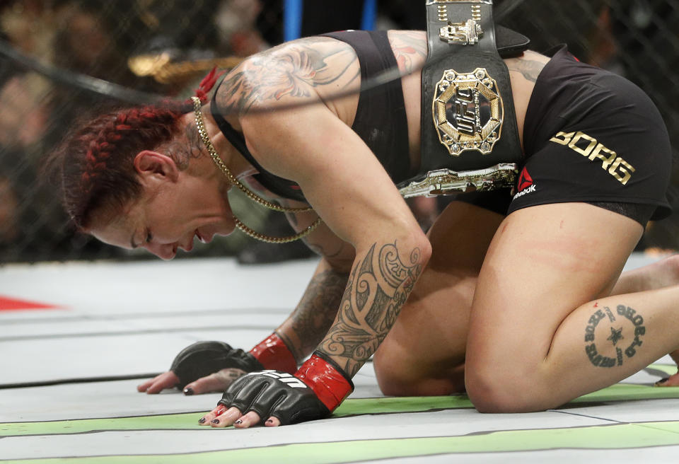 Cris Cyborg celebrates after defeating Holly Holm during a featherweight championship mixed martial arts bout at UFC 219, Saturday, Dec. 30, 2017, in Las Vegas. (AP Photo/John Locher)