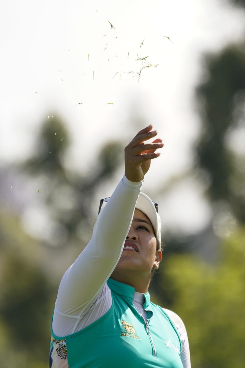 Jasmine Suwannapura throws grass in the air at the 17th tee during the final round of the LPGA's Palos Verdes Championship golf tournament on Sunday, May 1, 2022, in Palos Verdes Estates, Calif. (AP Photo/Ashley Landis)