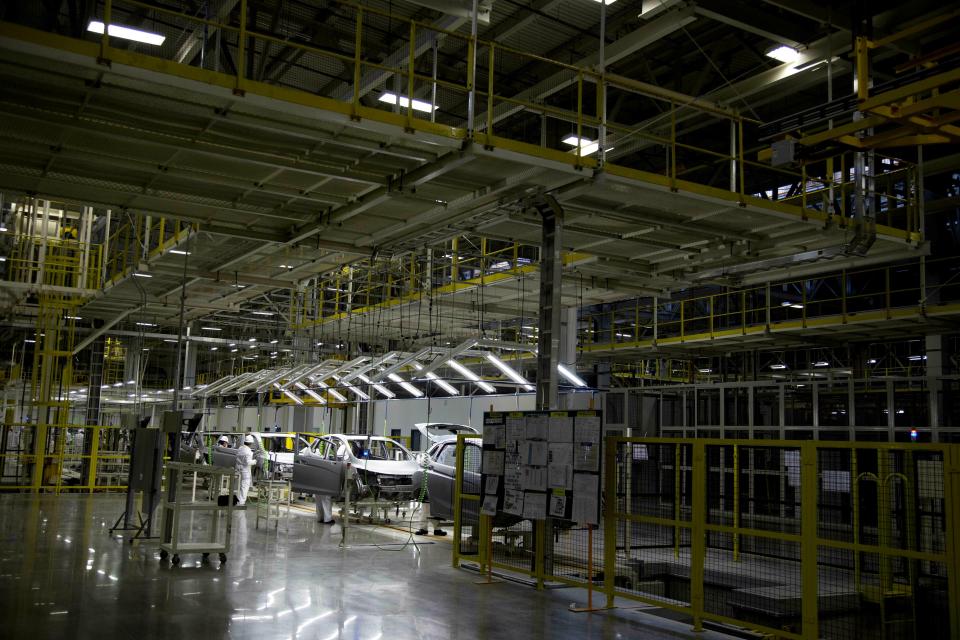 FILE- In this Feb. 21, 2014, file photo employees work in a Honda car plant in Celaya, in the central Mexican state of Guanajuato. Backing away from his vow to close America’s southern border, President Donald Trump on Thursday, April 4, 2019, and Friday promised instead that he’d slap tariffs on cars imported from Mexico if the illegal flow of people and narcotics doesn’t stop. (AP Photo/Eduardo Verdugo, File)