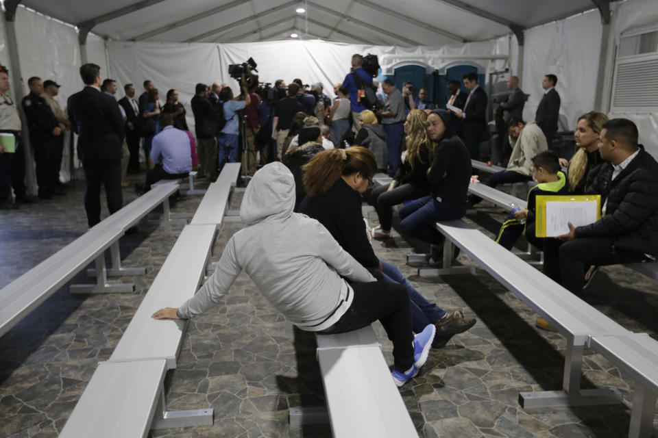 Migrants who are applying for asylum in the United States wait in a holding area at a new tent courtroom at the Migration Protection Protocols Immigration Hearing Facility, Tuesday, Sept. 17, 2019, in Laredo, Texas. (AP Photo/Eric Gay)