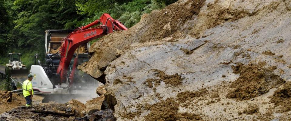 West Virginia Department of Highways workers seek to open highway closed by flashflood caused landslide in Nicholas County, West Virginia, USA on July 13, 2015