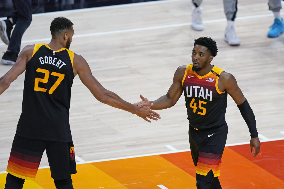 Utah Jazz's Rudy Gobert (27) congratulates Donovan Mitchell (45) after he scored against the Memphis Grizzlies during the first half of Game 5 of an NBA basketball first-round playoff series Wednesday, June 2, 2021, in Salt Lake City. (AP Photo/Rick Bowmer)