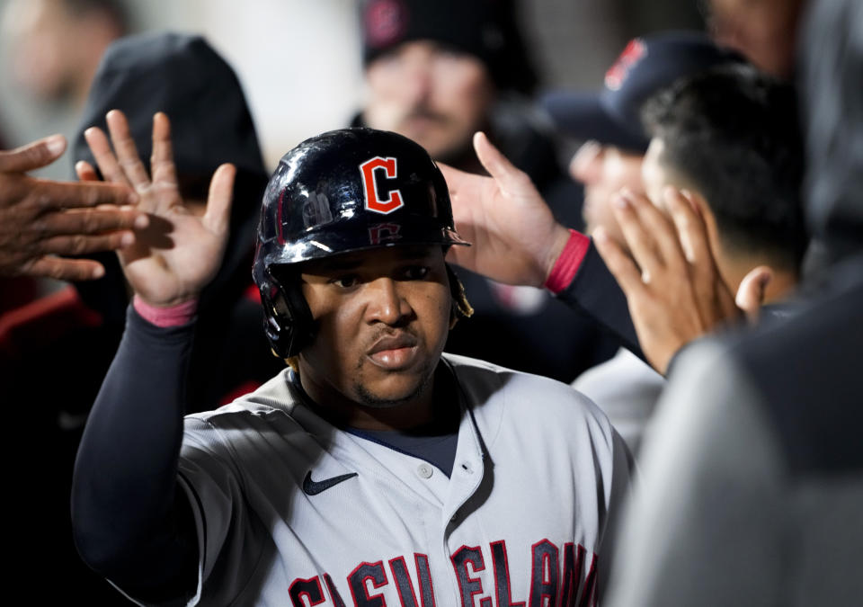 Cleveland Guardians' Jose Ramirez is greeted in the dugout after scoring against the Seattle Mariners on a single by Josh Naylor during the eighth inning of a baseball game Friday, March 31, 2023, in Seattle. The Guardians won 9-4. (AP Photo/Lindsey Wasson)