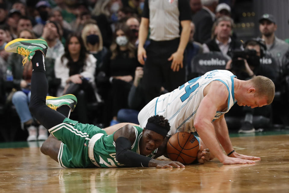 Charlotte Hornets' Mason Plumlee lands on Boston Celtics' Dennis Schroder chasing a loose ball during the second quarter of an NBA basketball game Wednesday, Jan. 19, 2022, in Boston. (AP Photo/Winslow Townson)