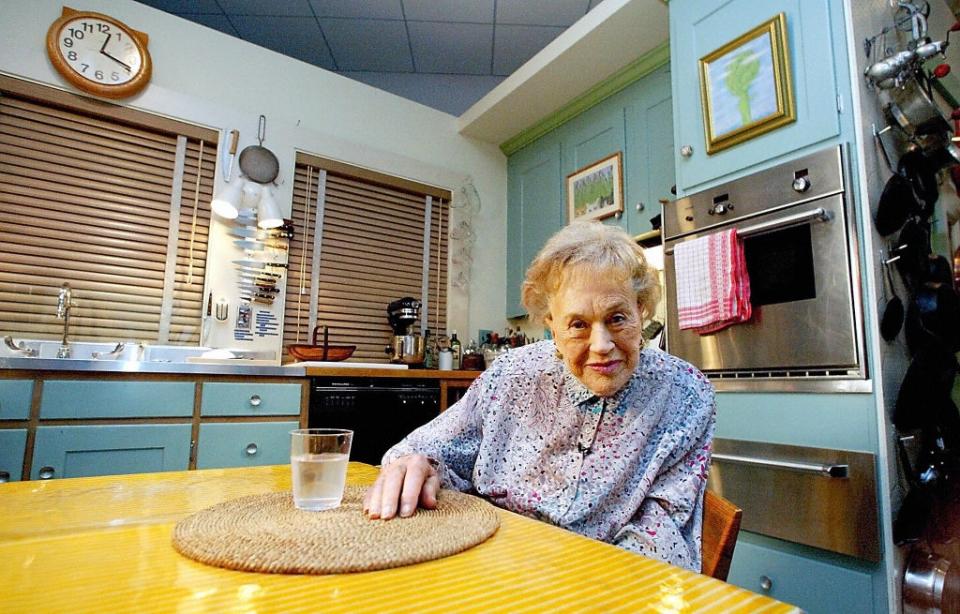 Julia Child sitting in her kitchen at the National Museum of American History in Washington, DC on 19 August 2002 (TIM SLOAN/AFP via Getty Images)