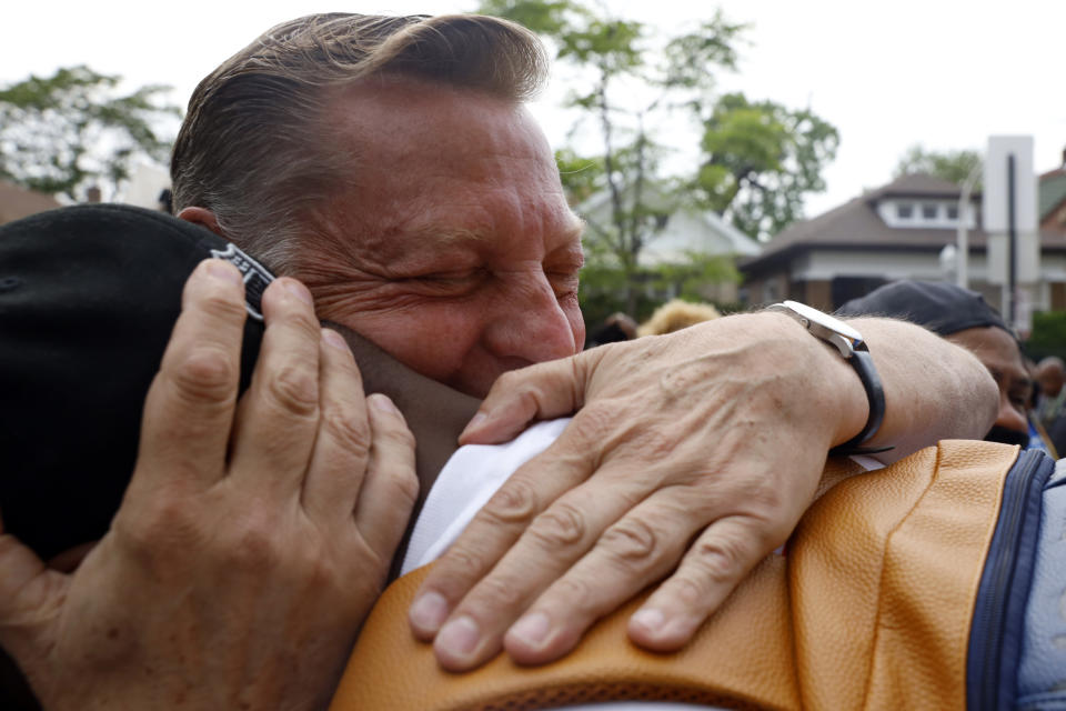 Father Michael Pfleger hugs one of his supporters after the press conference following his reinstatement by Archdiocese of Chicago, Monday, May 24, 2021, in front of St. Sabina Catholic Church in the Auburn Gresham neighborhood in Chicago. (AP Photo/Shafkat Anowar)
