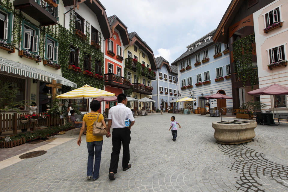 A family walks in the Chinese replica of the Austrian village of Hallstatt in Huizhou, Guangdong province, on June 1, 2012. (Siu Chiu / Reuters file)