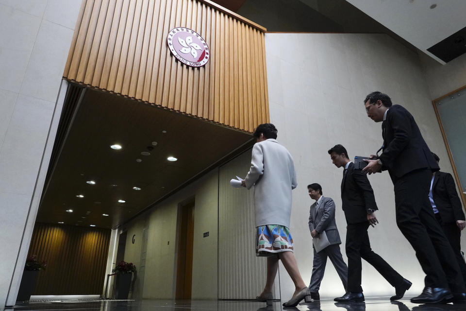 Hong Kong Chief Executive Carrie Lam, left, leaves after given a press conference in Hong Kong, Tuesday, Nov. 26, 2019. Lam has refused to offer any concessions to anti-government protesters after a local election setback. (AP Photo/Vincent Yu)