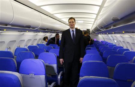 Serbia's Deputy Prime Minister Aleksandar Vucic walks inside a new Airbus 319 plane in Belgrade October 25, 2013. REUTERS/Marko Djurica