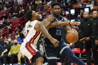 Memphis Grizzlies forward Jaren Jackson Jr. (13) drives to the basket as Miami Heat guard Kyle Lowry (7) defends during the first half of an NBA basketball game, Monday, Dec. 6, 2021, in Miami. (AP Photo/Marta Lavandier)