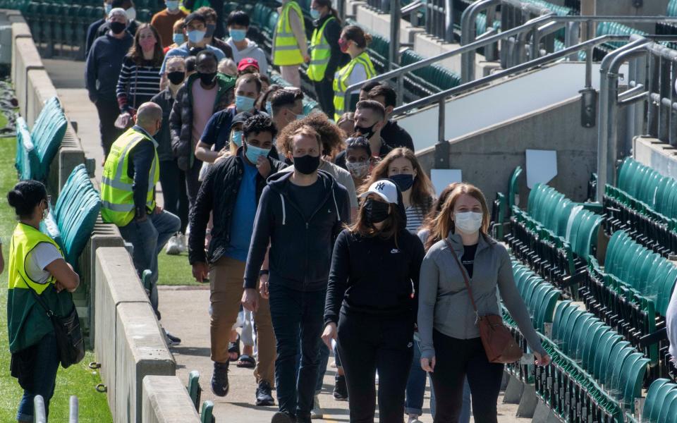 People queuing around the pitch inside Twickenham Stadium as it hosts the biggest walk-in vaccination event for residents of northwest London on Bank Holiday Monday - JULIAN SIMMONDS