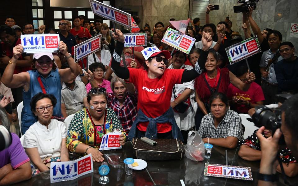 Supporters of Pheu Thai react to the election results - AFP