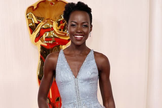 <p>Mike Coppola/Getty</p> Lupita Nyong'o attends the 2024 Oscars in a Armani gown nodding to the dress she wore to the 2014 ceremony