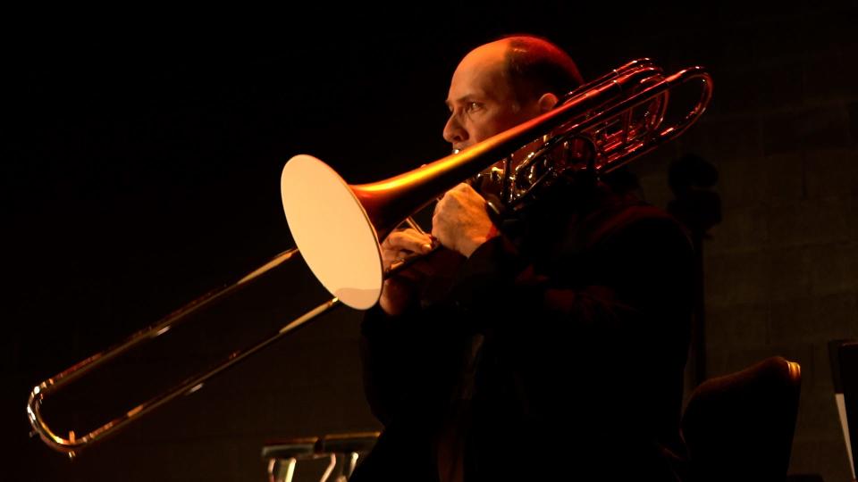 J. Bryan Heath, bass trombone with the Louisville Orchestra. To continue performing during the pandemic, The Louisville Orchestra has moved to Paristown Hall and is practicing social distancing on stage, masked instruments (and performers) plexiglass barriers between musicians plus an altered configuration of where musicians are seat.