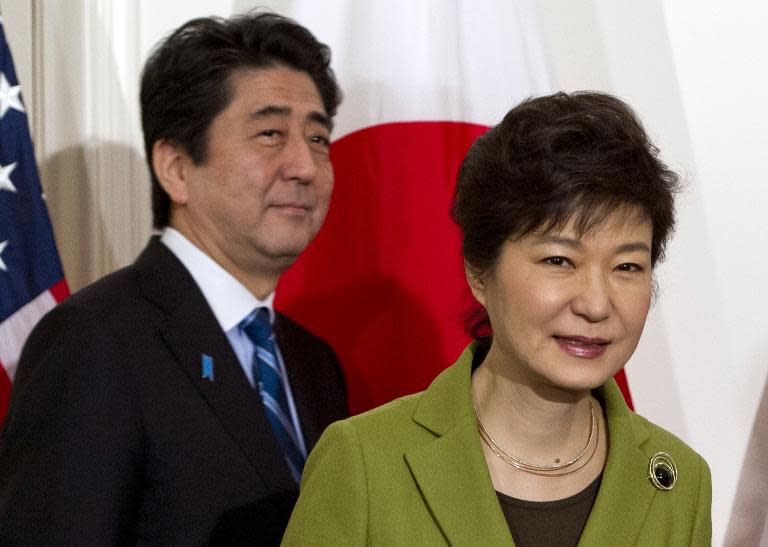 South Korean President Park Geun-hye and Japanese Prime Minister Shinzo Abe arrive for a trilateral meeting with the US president in The Hague on March 25, 2014