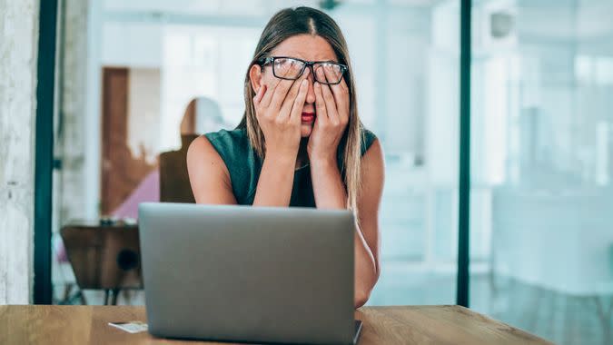 Shot of a stressed businesswoman with headache in the office.