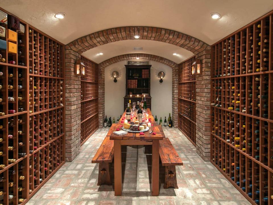 a wine cellar surrounded by brick walls and floors