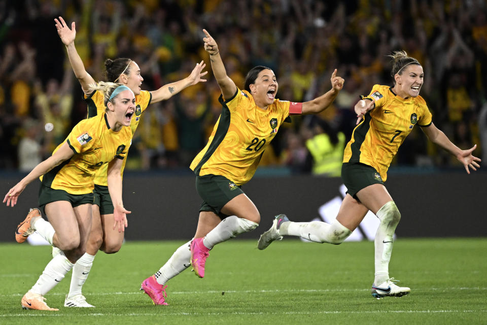 Australia's from left, Ellie Carpenter, Caitlin Foord, Sam Kerr and Steph Catley celebrate after Cortnee Vine kicked the winning penalty goal to defeat France in the Women's World Cup quarterfinal soccer match between Australia and France in Brisbane, Australia, Saturday, Aug.12, 2023. (Darren England/AAPImage via AP)