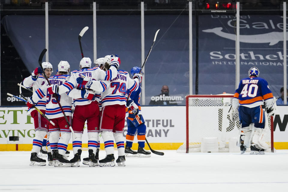 New York Islanders goaltender Semyon Varlamov (40) stands at the goal as the New York Rangers celebrate a goal by Kevin Rooney during the second period of an NHL hockey game Tuesday, April 20, 2021, in Uniondale, N.Y. (AP Photo/Frank Franklin II)