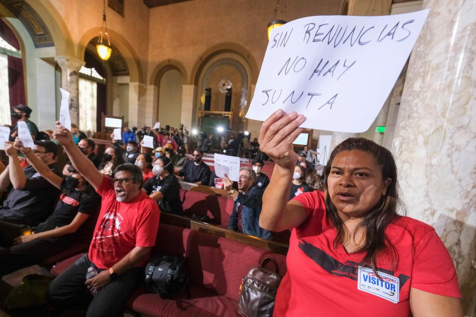 Ofelia Platon, right, from Oaxaca, holds a sign while protesting before the cancellation of the Los Angeles City Council meeting on Oct. 12, 2022.