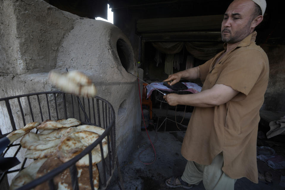 A worker prepare 'Naan' at a ran locally called 'Tandoor' in a a neighbourhood, where mostly Afghan populations, in Karachi, Pakistan, Friday, Jan. 26, 2024. For more than 1 million Afghans who fled war and poverty to Pakistan, these are uncertain times. Since Pakistan announced a crackdown on migrants last year, some 600,000 have been deported and at least a million remain in Pakistan in hiding. They've retreated from public view, abandoning their jobs and rarely leaving their neighborhoods out of fear they could be next. It's harder for them to earn money, rent accommodation, buy food or get medical help because they run the risk of getting caught by police or being reported to authorities by Pakistanis. (AP Photo/Fareed Khan)