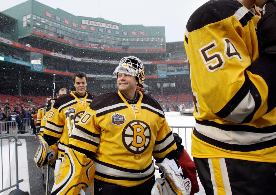 Boston Bruins players including goalie Tim Thomas, center, walk to the ice rink to practice at Fenway Park in Boston on Thursday, Dec. 31, 2009, in preparation for New Years Day's Winter Classic NHL hockey game against the Philadelphia Flyers. (AP Photo/Elise Amendola)