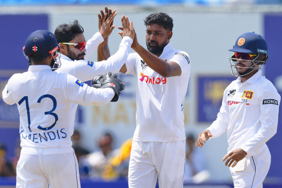 Sri Lanka's Prabath Jayasuriya, second right, celebrates with teammates the wicket of New Zealand's Mitchell Santner on the third day of the first cricket test match between New Zealand and Sri Lanka in Galle, Sri Lanka, Friday, Sept. 20, 2024. (AP Photo/Viraj Kothalawala)