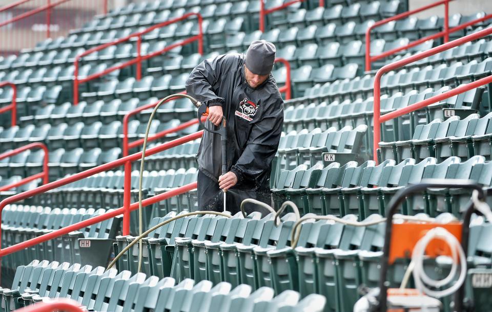 Phil Kienholz, 38, helps clean UPMC Park on April 4, preparing for Tuesday's home opener.