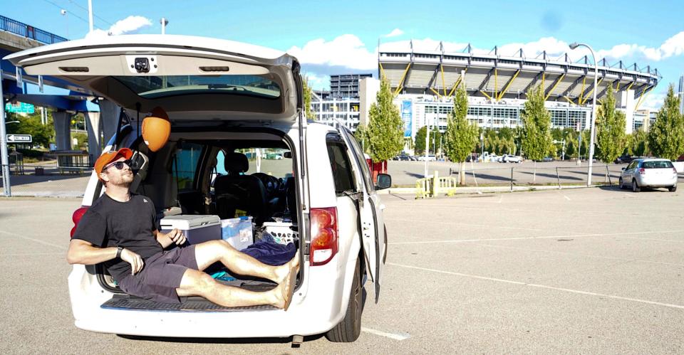 Ben Chase relaxes in "Betty White" — the minivan he drove more than 60,000 miles (and often slept in) to attend 77 college football games this season.