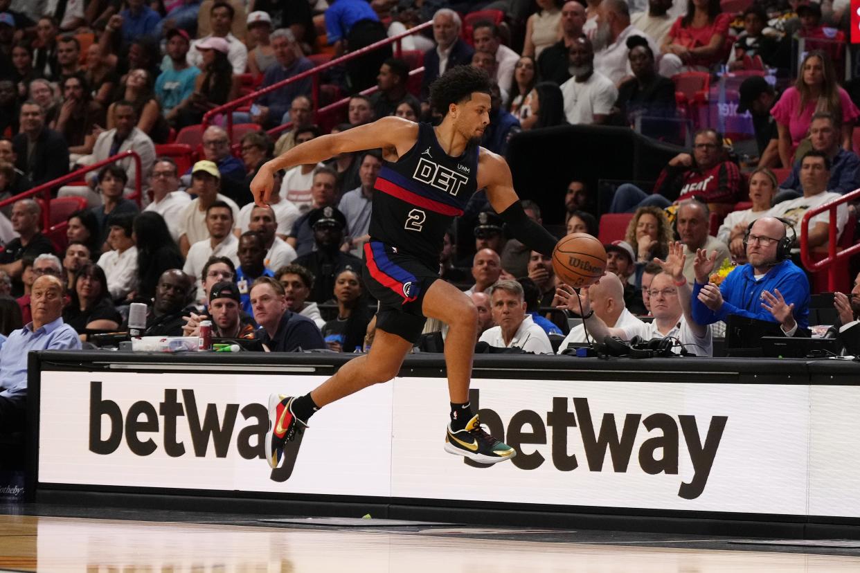 Detroit Pistons guard Cade Cunningham (2) attempts to keep the ball in bounds against the Miami Heat during the first half at Kaseya Center in Miami on Wednesday, Oct. 25, 2023.