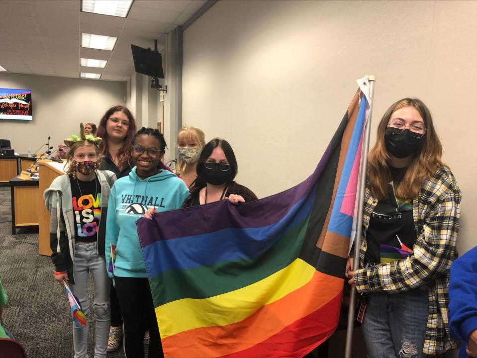 Waukesha students Autumn Gilligan, Gigi Mickschl, Kayla Kohn, Desi Levenhagen, Allyson Kulinski and Miah Miner display a rainbow flag during a school board meeting Oct. 13, 2021 in Waukesha, Wis. It was the second month of public comments about a new rule that bans teachers from displaying &quot;controversial&quot; decorations in classrooms.