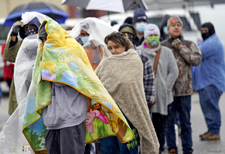 People wait in line to fill propane tanks on Wednesday in Houston.