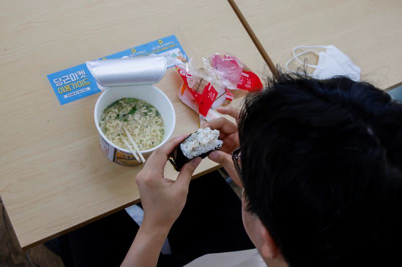 An office worker eats his lunch at a convenience store in Seoul