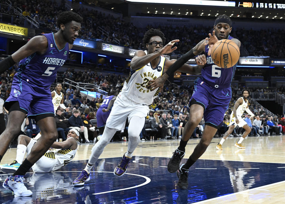 Indiana Pacers forward Jalen Smith (25) and Charlotte Hornets forward Jalen McDaniels (6) lunge for a the ball during the second half of an NBA basketball game, Sunday, Jan. 8, 2023, in Indianapolis. (AP Photo/Marc Lebryk)