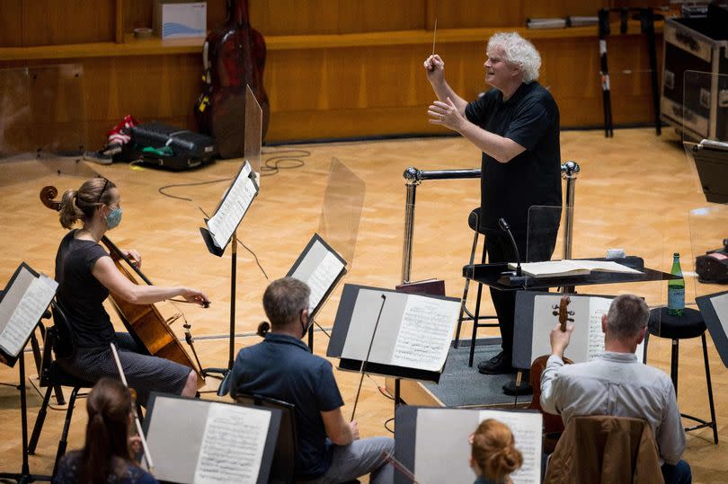 British conductor Simon Rattle conducts during a rehearsal of Tristan und Isolde by the London Symphony Orchestra at St Lukes Church in central London on June 10, 2021.