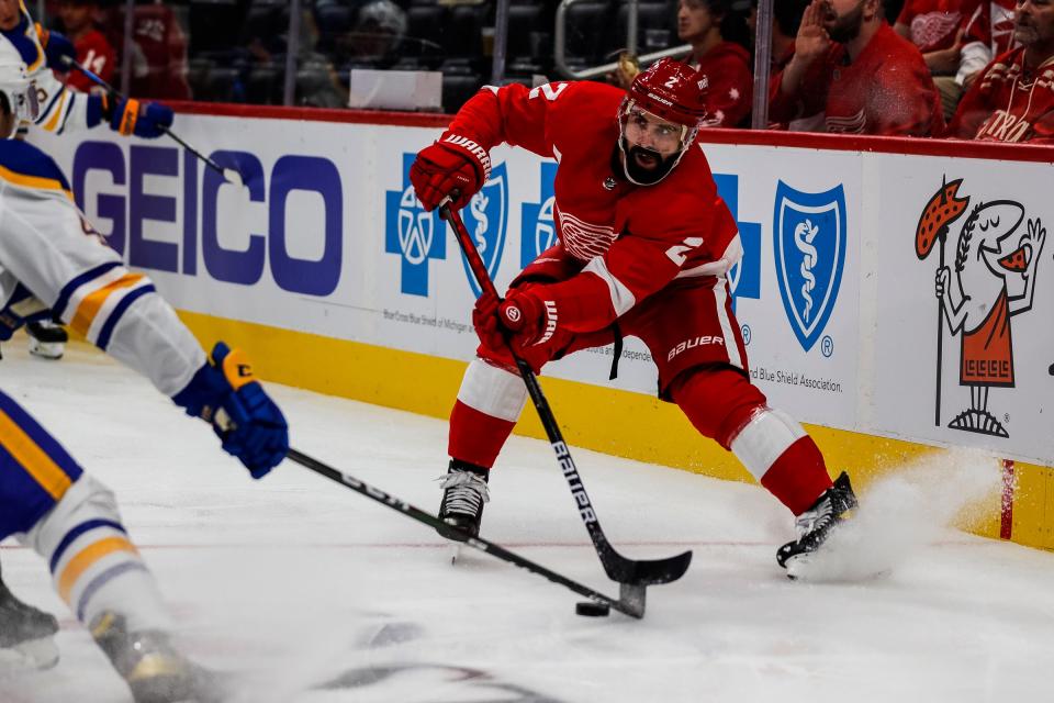 Detroit Red Wings defenseman Nick Leddy (2) protects the puck against the Buffalo Sabres left wing Brendan Warren (42) during the second period of a preseason game at Little Caesars Arena in Detroit on Thursday, Sept. 30, 2021.