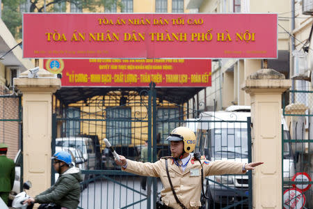 A policeman directs traffic in front of a court in Hanoi, Vietnam January 8, 2018. REUTERS/Kham