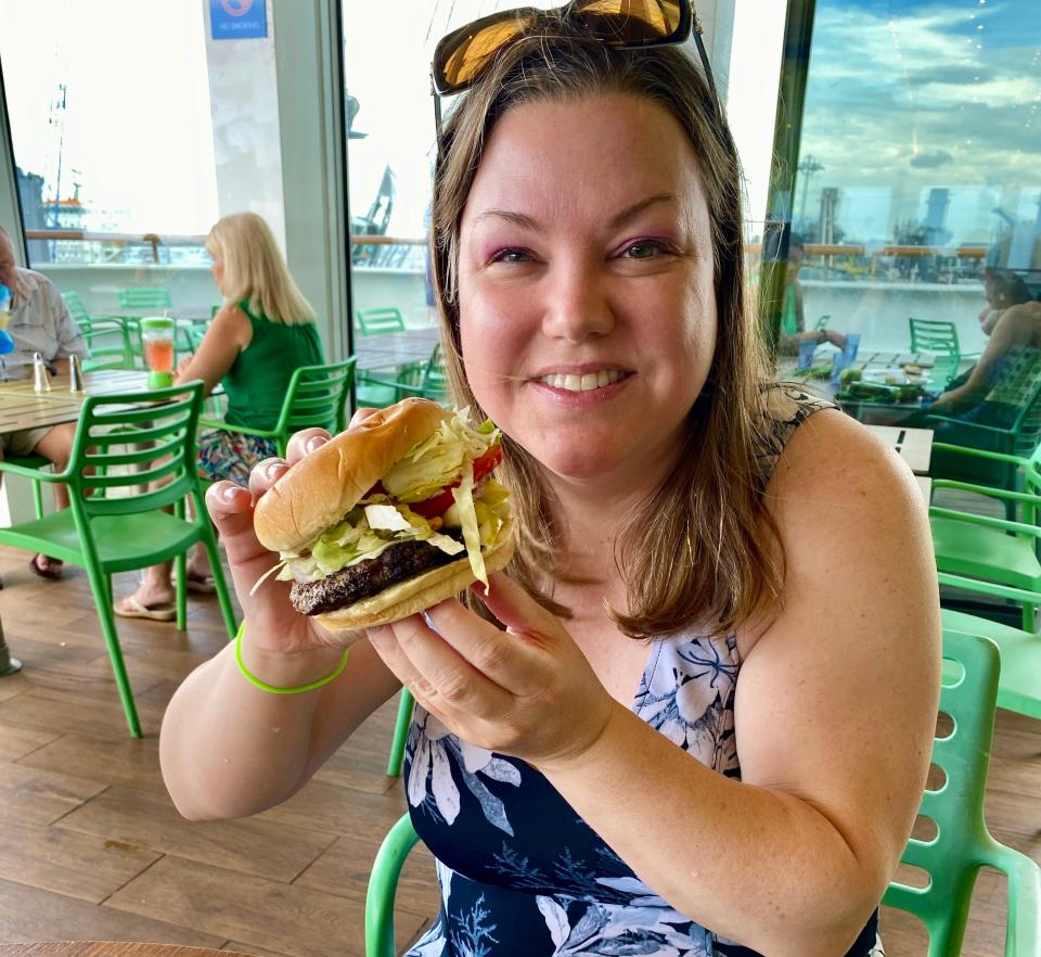 lauren mack holding hamburger on margaritaville at sea