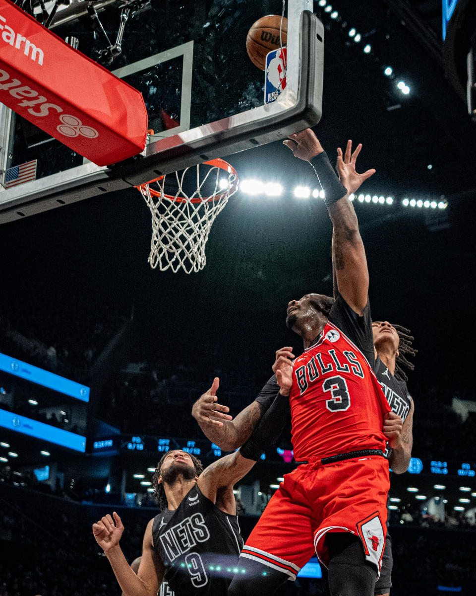 Chicago Bulls' Andre Drummond (3) shoots against Brooklyn Nets' Trendon Watford (9) and Noah Clowney, rear, during the first half of an NBA basketball game in New York, Friday, March 29, 2024. (AP Photo/Peter K. Afriyie)