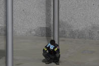 CAPTION CORRECTS THE DATE - In this photo taken on Thursday, April 2, 2020, a firefighter talks on his phone as he rests at a temporary field hospital set in Ifema convention and exhibition in Madrid, Spain. Most of the 1,850 patients brought to the Ifema field hospital are not in serious conditions. In fact, 800 had been discharged by Thursday, although six had died since doors opened 12 days ago. The new coronavirus causes mild or moderate symptoms for most people, but for some, especially older adults and people with existing health problems, it can cause more severe illness or death. (AP Photo/Manu Fernandez)