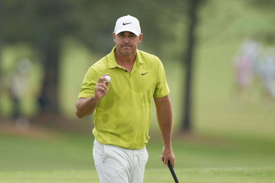Brooks Koepka waves after his putt on the 18th hole during the first round of the Masters golf tournament at Augusta National Golf Club on Thursday, April 6, 2023, in Augusta, Ga. (AP Photo/Charlie Riedel)
