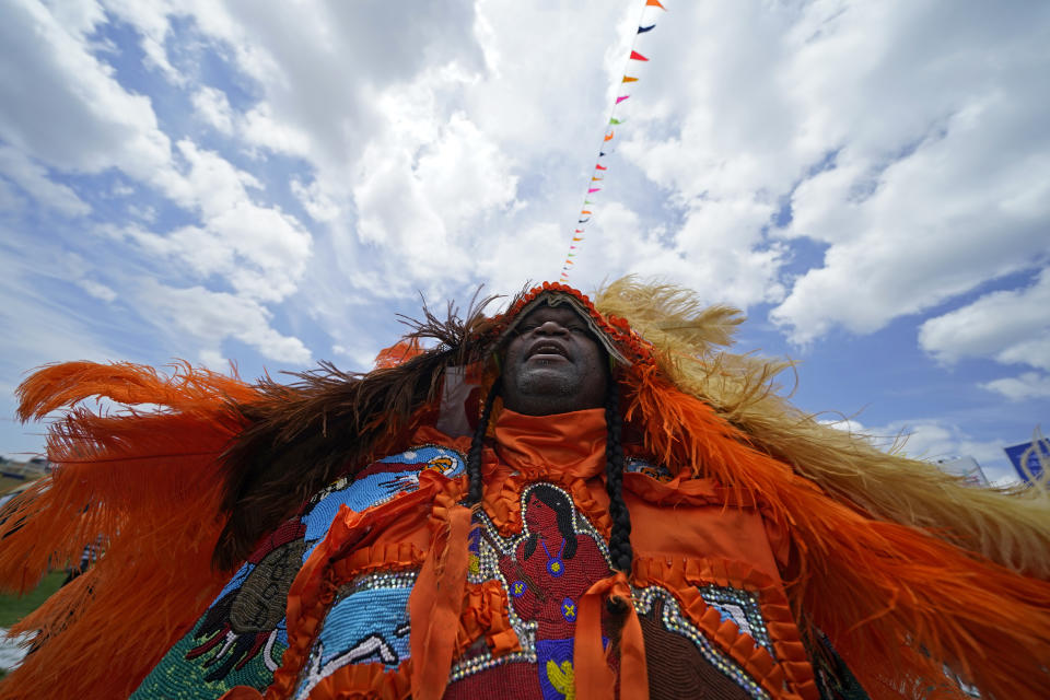 Big Chief Cantrell Watson, of the New Orleans Mardi Gras Indian tribe Wild Mohicans, parades through the New Orleans Jazz & Heritage Festival in New Orleans, Friday, April 29, 2022. (AP Photo/Gerald Herbert)