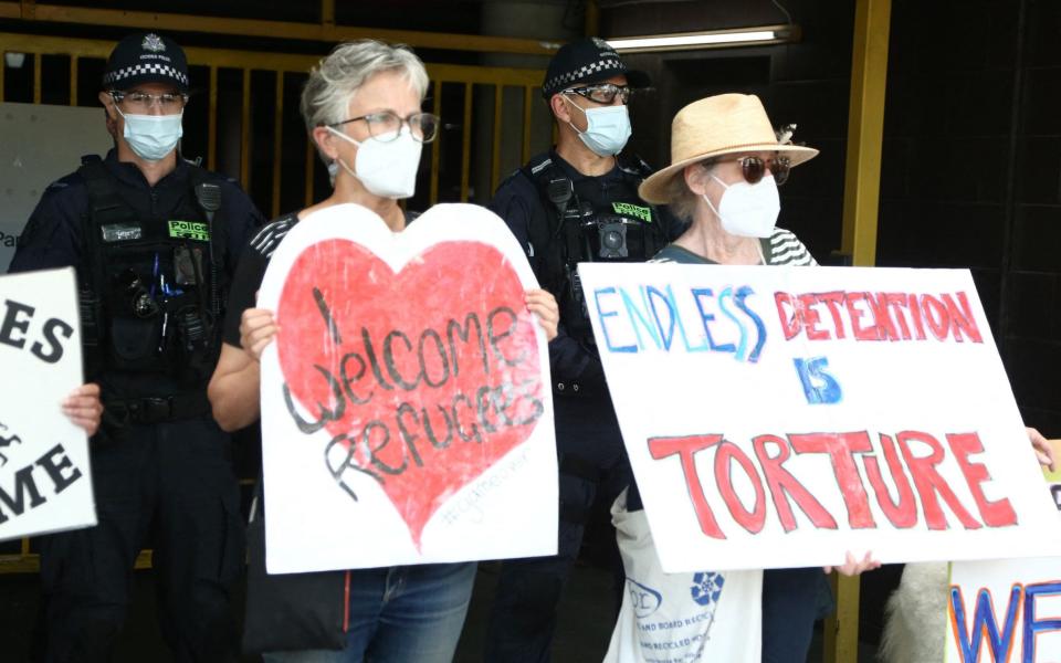 Police stand in front of the Park Hotel car park entrance before Serbian tennis player Novak Djokovic arrives ahead of the Australian Open tennis tournament in Melbourne on January 14, 2022. (Photo by BRANDON MALONE / AFP) / -- IMAGE RESTRICTED TO EDITORIAL USE - STRICTLY NO COMMERCIAL USE -- (Photo by BRANDON MALONE/AFP via Getty Images) - AFP/Brandon Malone